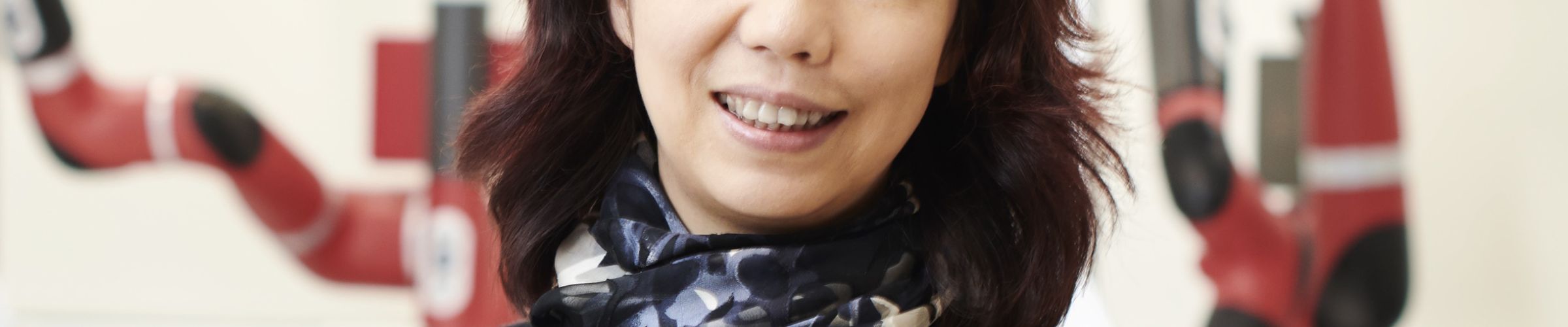 A color photo of a woman smiling for a photo