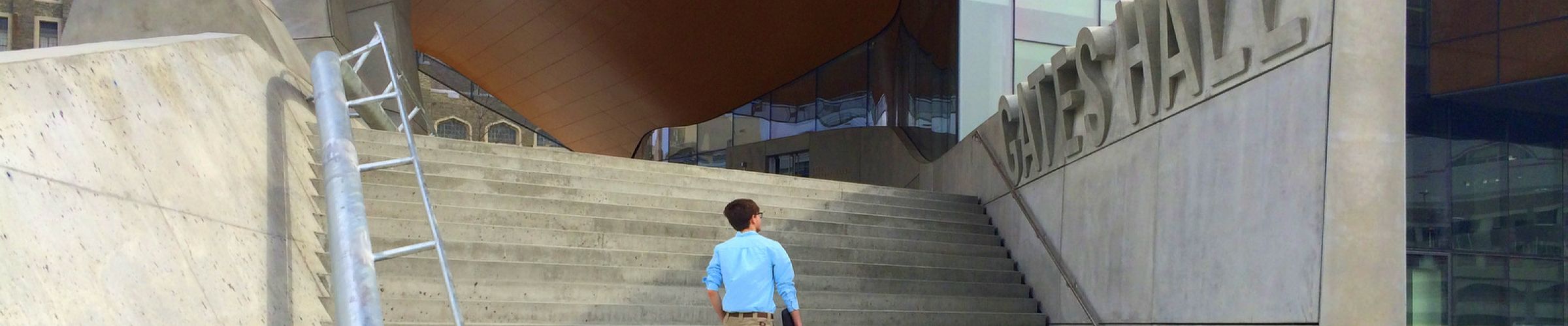 student walking up steps of Gates Hall