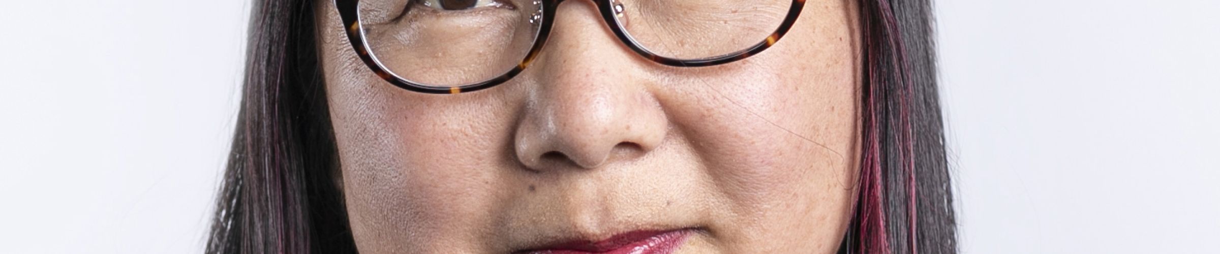 A color photo of a woman, Wendy Ju, smiling for a photo