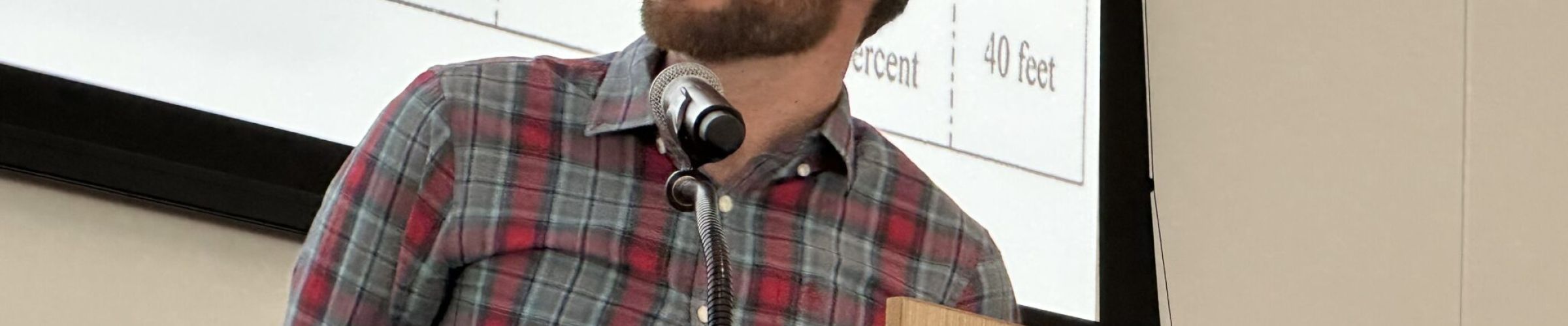 A color photo of a man presenting research