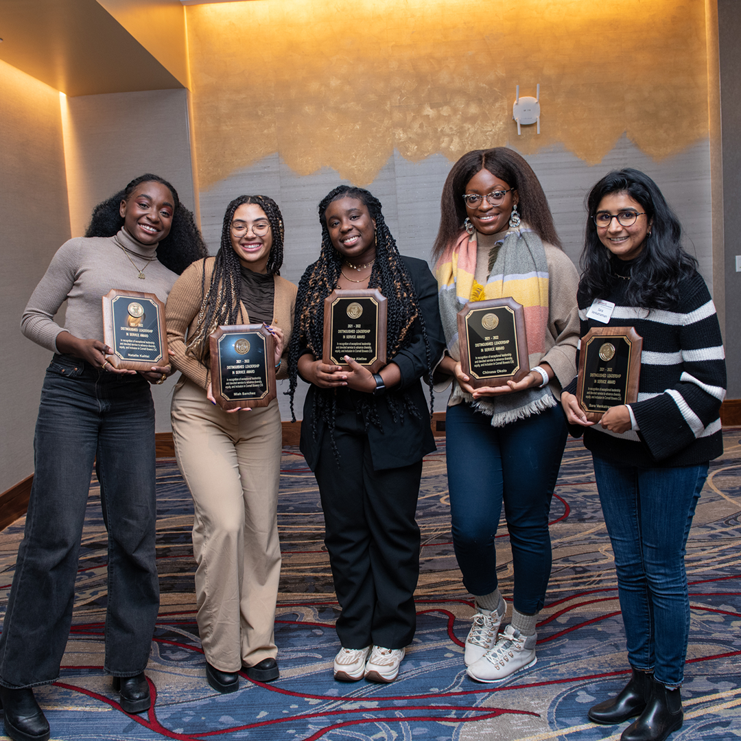 A color photo showing a group of award winners with their awards