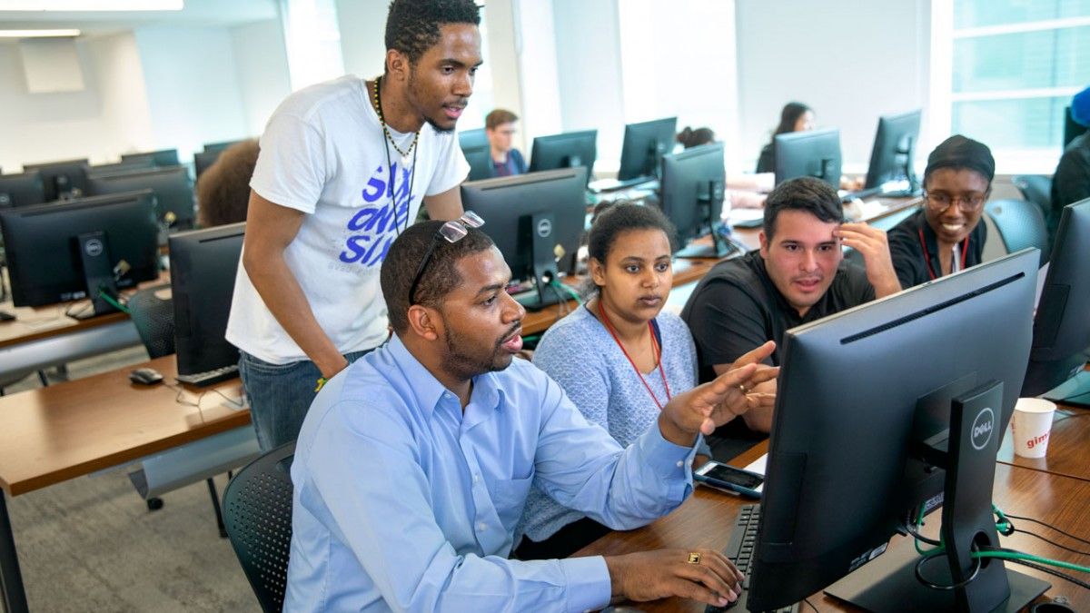 Hakim Weatherspoon, professor of computer science, works with students during the 2019 SoNIC Workshop program in Upson Hall. CREDIT: Jason Koski, Cornell University