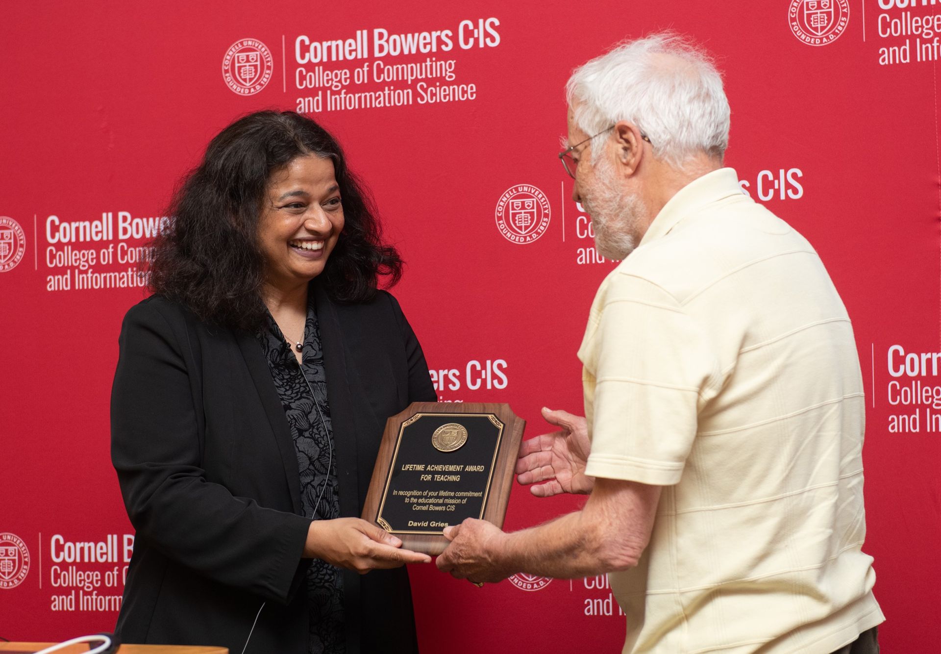 Dean Kavita Bala presents David Gries with the Lifetime Achievement Award in Teaching for his 51 years as an educator in Cornell’s Department of Computer Science.