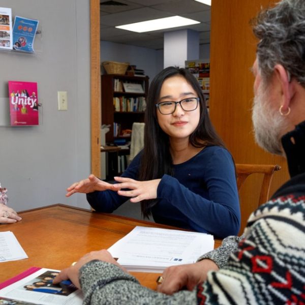 Ryan Young/Cornell University Ying Lin Zhao ’26, center, works with Amy LeViere ’95, left, chief philanthropic services and systems officer, and CEO George Ferrari ’84 at the Tompkins County Community Foundation.