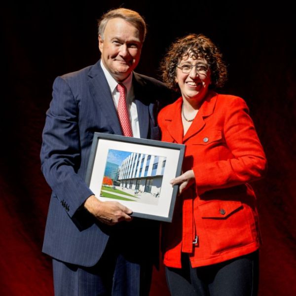 Kraig Kayser, left, chairman of the Cornell Board of Trustees, presents President Emerita Martha E. Pollack with a photo of the plaza that will be named in her honor.