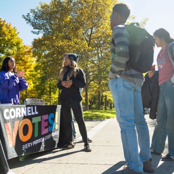 Credit: Jason Koski/Cornell University Caption: Students from the Cornell Policy Group, a nonpartisan student organization, help others register to vote on Ho Plaza.