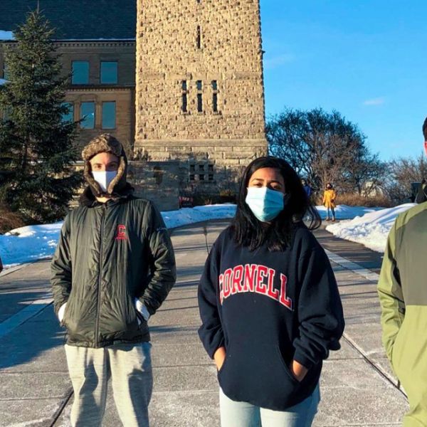 four students outside on Cornell's campus