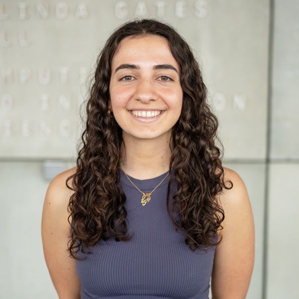 A color photo of a woman smiling for a photo