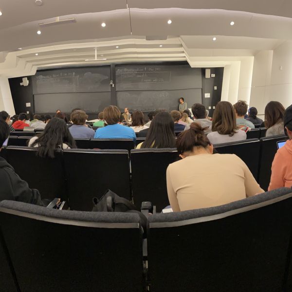 A color photo of a crowded lecture hall