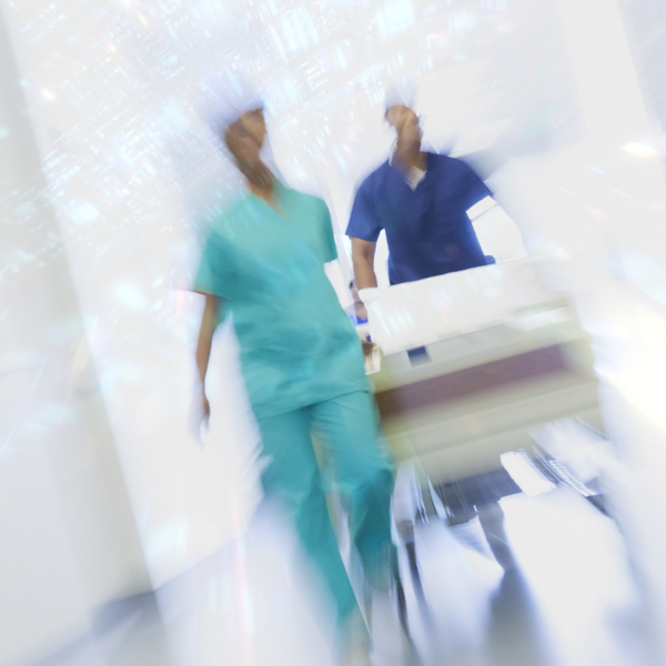 A blurred photo of a doctor and nurse rushing through a hallway