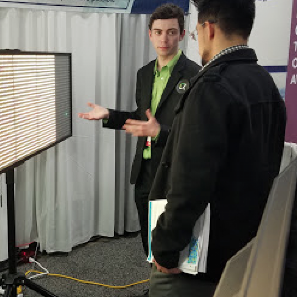 students talking in front of a TV