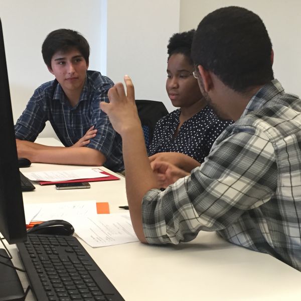 Three SoNIC participants discuss a coding challenge
