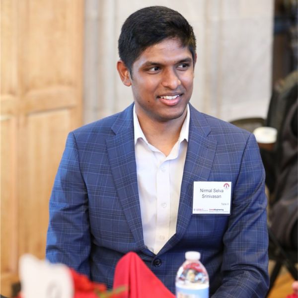 A color photo of a man smiling for a photo