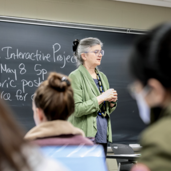 A color photo showing Liz Karns, senior lecturer in social statistics, teaching students in Integrated Data Science.