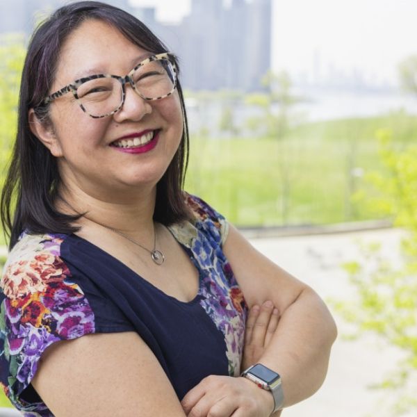 A color photo of a woman smiling for a photo