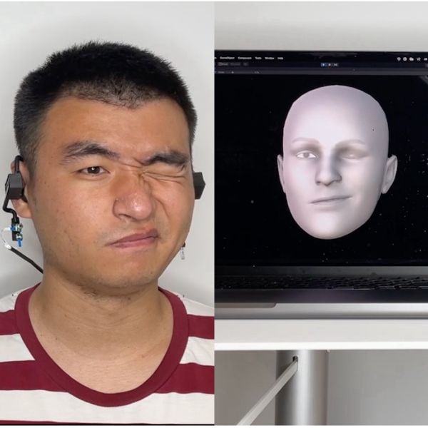 A man in a striped shirt makes faces that are recreated on a computer screen as an avatar of himself