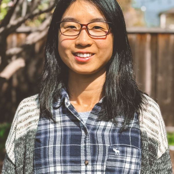 A color photo of a woman smiling for a photo