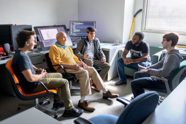 Greenburg sits with students in classroom