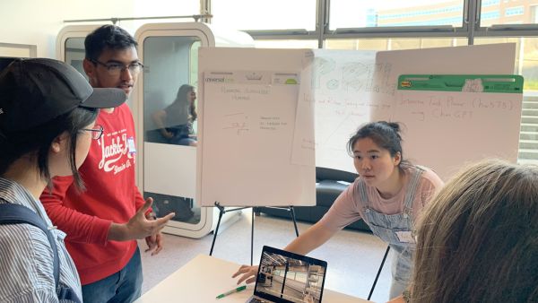 PoRTal (People and Robots Teaching and Learning) A color photo showing a man and woman presenting their project during ACSU Research Night.