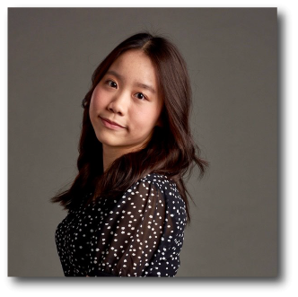 A color photo of a woman smiling for a photo