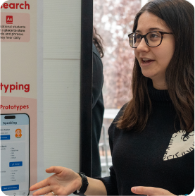 A color photo of a woman giving a presentation