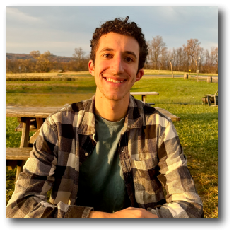 A color photo of a man smiling for a photo