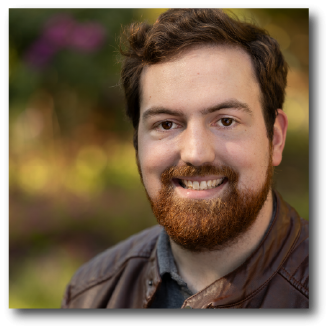 A color photo of a man smiling for a photo