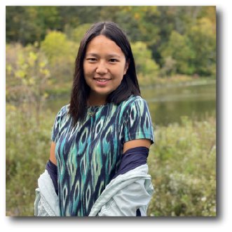 A color photo of a woman smiling for a photo