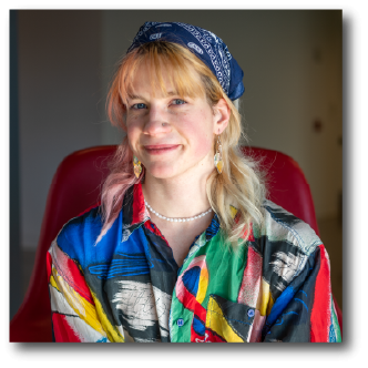 A color photo of a woman smiling for a photo