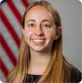 A color photo of a woman smiling for a photo