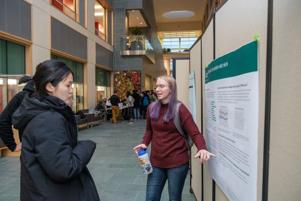CAPTION: Julia Atkins, a student in the master of professional studies (MPS) program in information science, pitches her survey of existing research on linguistic differences in communication between women and men during a student showcase held Dec. 6.  
