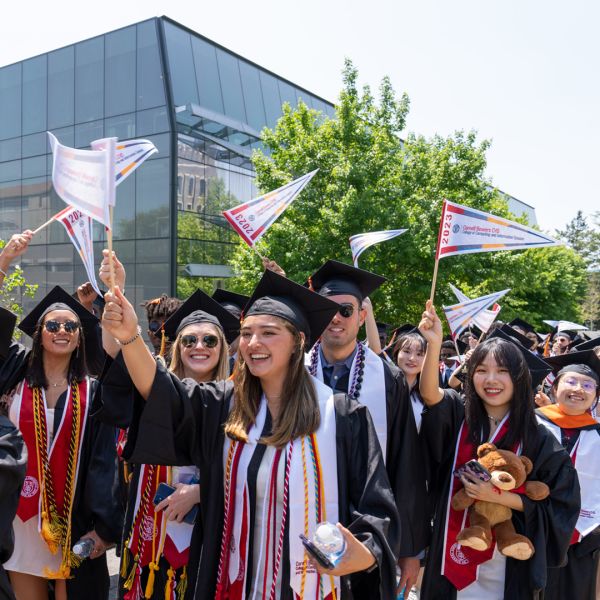 A color photo showing the recent graduates from Cornell Bowers CIS marching during commencement