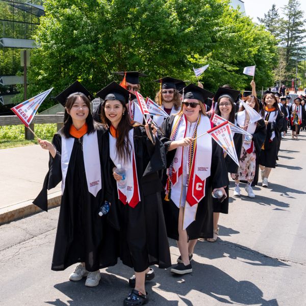 A color photo showing the recent graduates from Cornell Bowers CIS marching during commencement