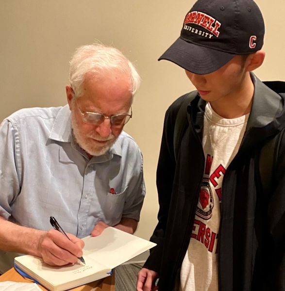 Following his lecture, Professor Gries signs his landmark book, “The Science of Programming” for a student Gries signs a notebook of a student