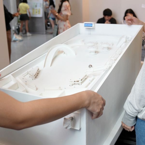 A color photo showing a white pinball machine