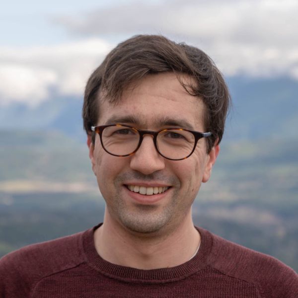 A color photo of a man smiling for a photo