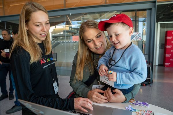 women showing family images on computer