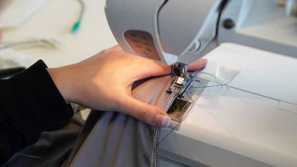Photos by Louis DiPietro/Provided Yu uses a home sewing machine to couch the conductive threads into the seams.