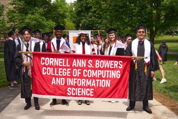 A color photo showing people matching at commencement