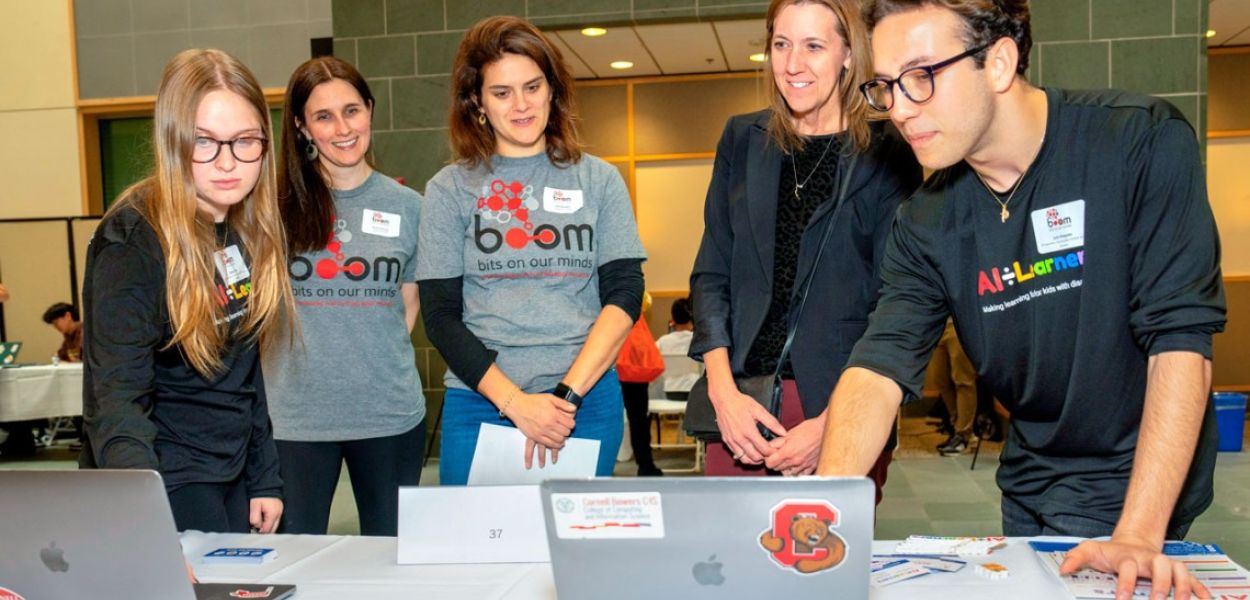 Dave Burbank for Cornell University At BOOM 2023, students demonstrate AI-Learners, a platform that helps kids learn math and literacy with games.