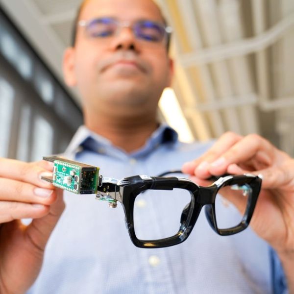 A color photo showing Saif Mahmud, a doctoral student in the field of information science, with PoseSonic glasses.