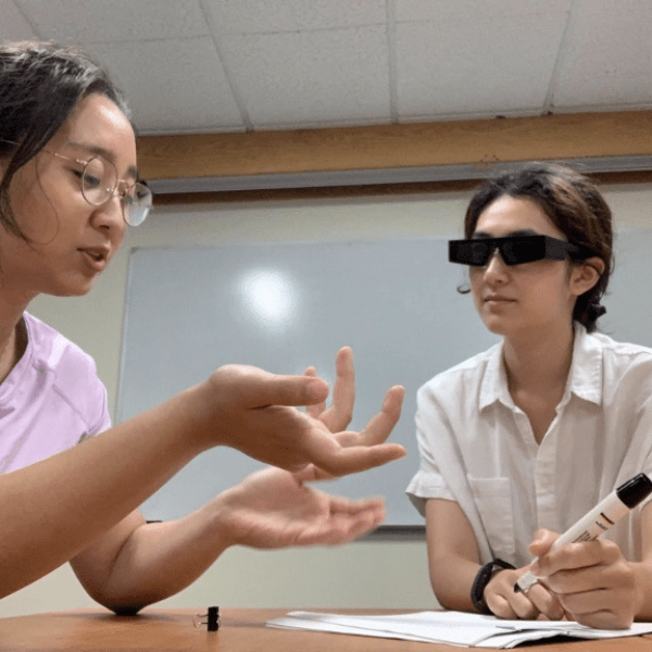 A pair of participants in the new study have a discussion while one person wears augmented reality (AR) glasses. Credit: Provided