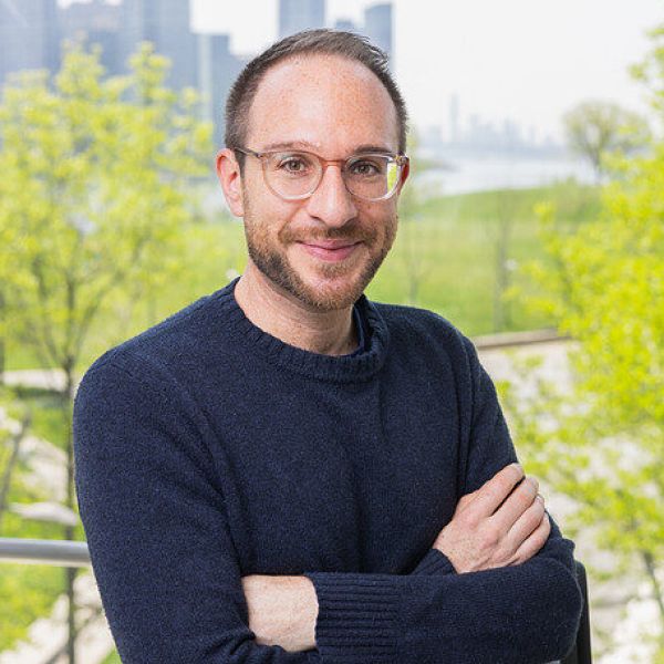 A color photo of a man smiling for a photo
