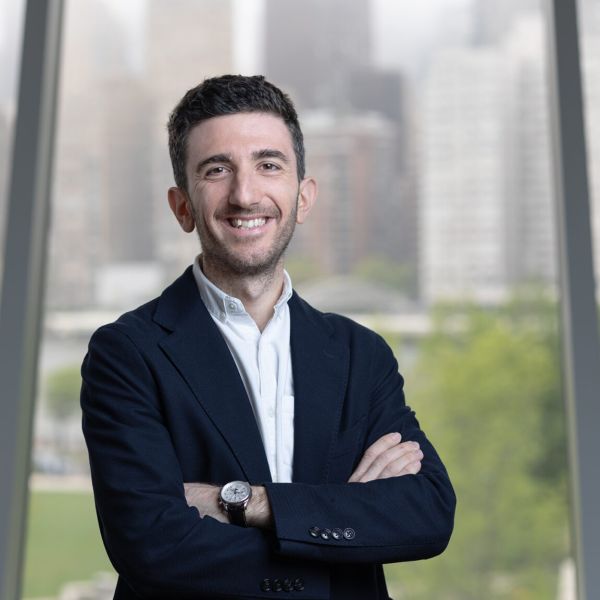 A color photo of a man smiling for a photo