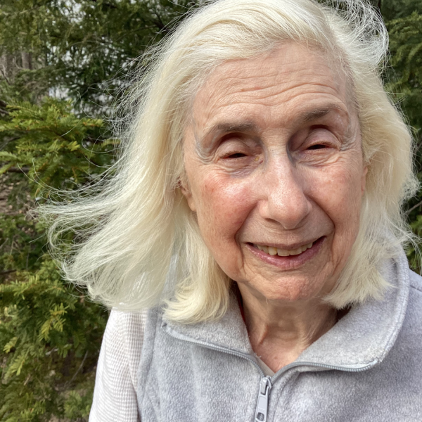 A color photo of a woman smiling for a photo