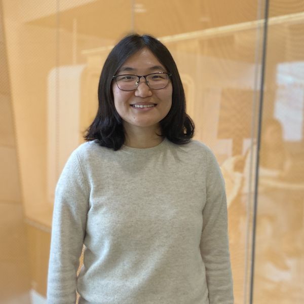 A color photo of a woman smiling for a photo