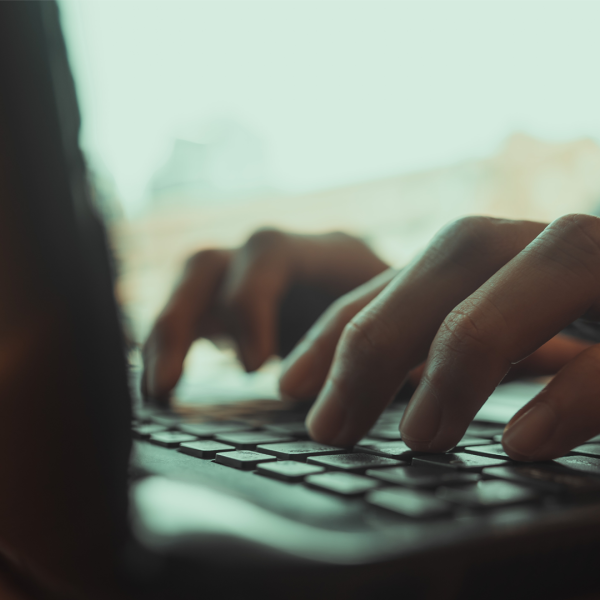 Close focus of man's hands typing Credit: Shutterstock