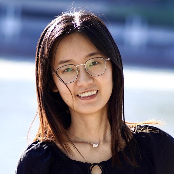 Color photo of a woman wearing glasses and smiling