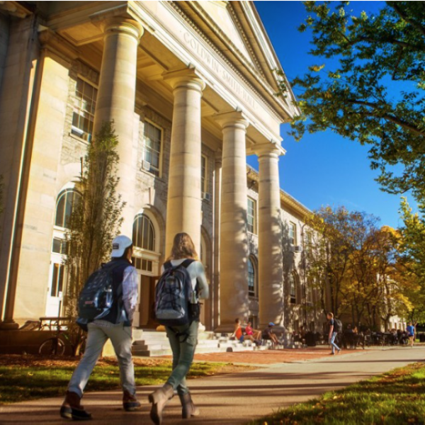 photo of students walking outside of a building
