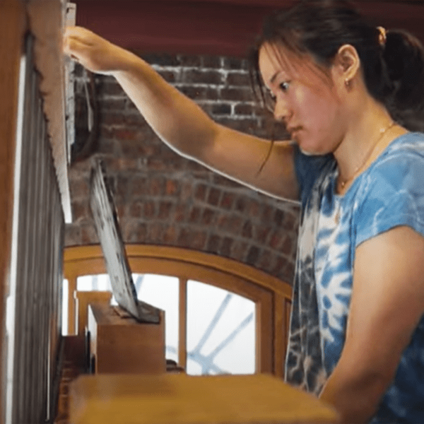 A color photo of a woman, Chenchen Lu, playing the Cornell chimes